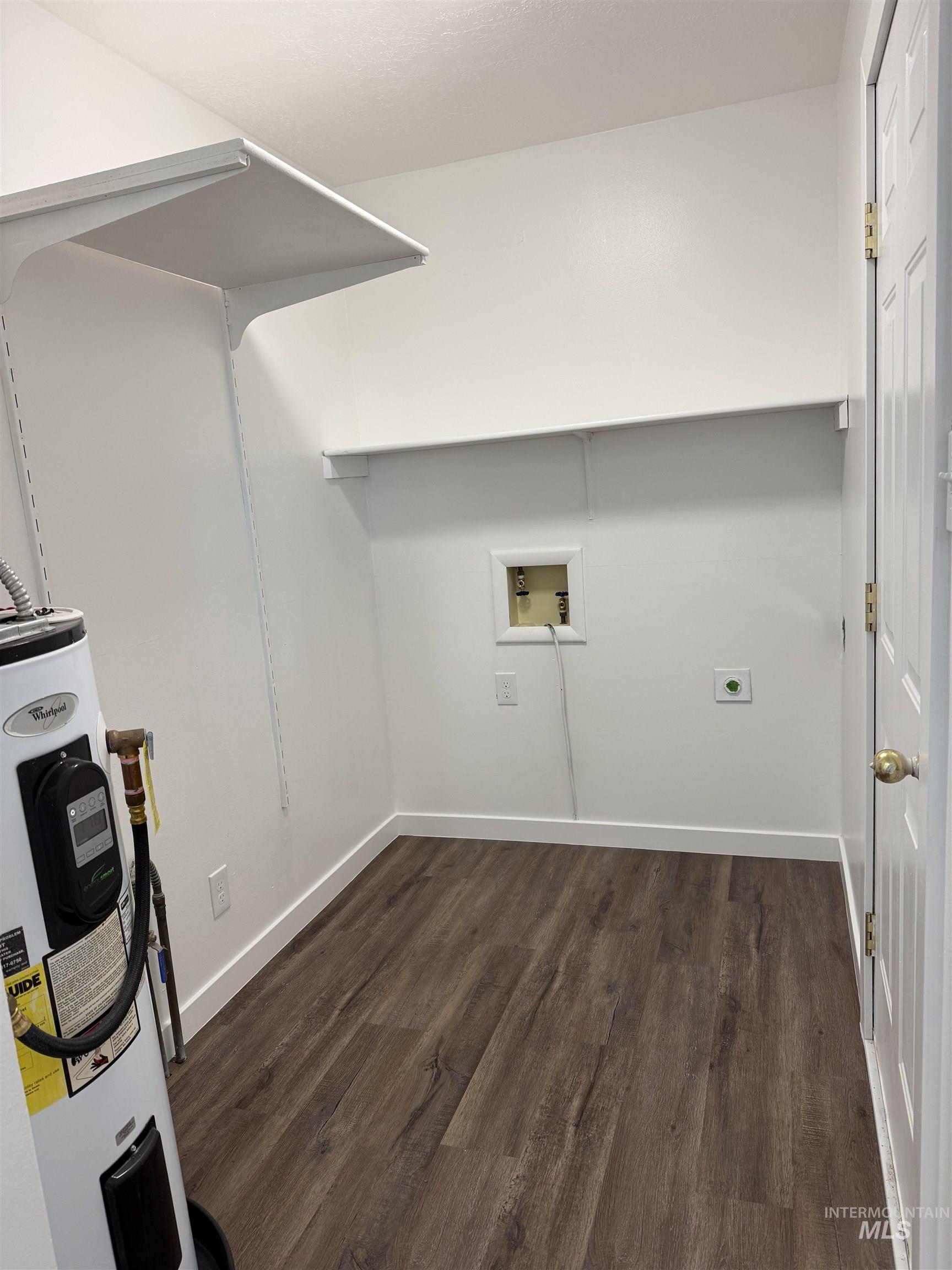 709 Locust Street Kimberly, ID 83341 - Photo 8 of 13 Laundry room featuring dark wood-type flooring, electric water heater, and washer hookup