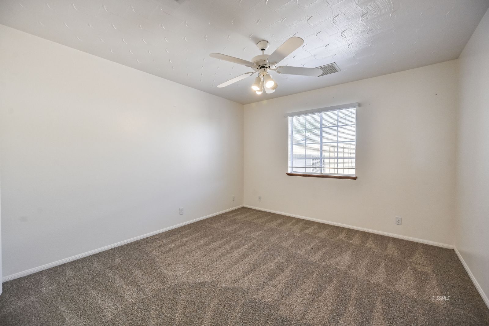 1209 West Robert Avenue Ridgecrest, CA 93555 - Photo 29 of 50 an empty room with windows and fan
