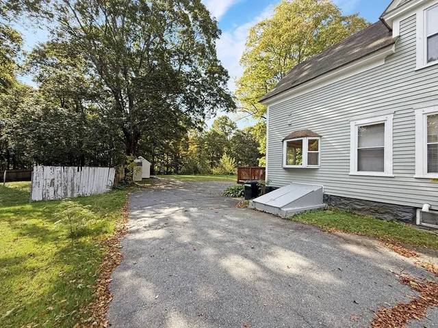 a view of a backyard with tree