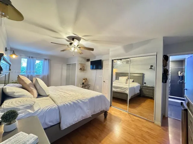 a bedroom with a large bed and a dresser