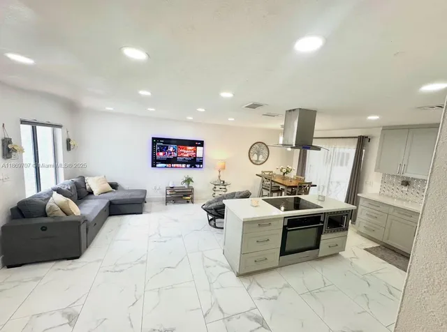 a living room with furniture and white walls