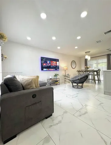 a living room with furniture and a glass table
