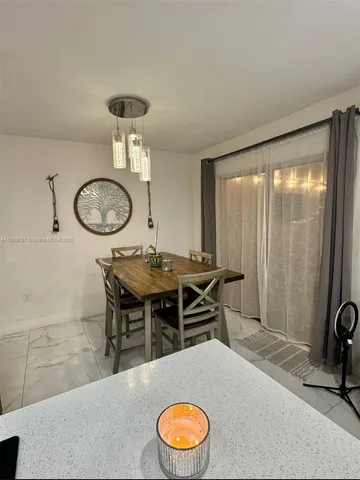 a living room with furniture a rug and a large window