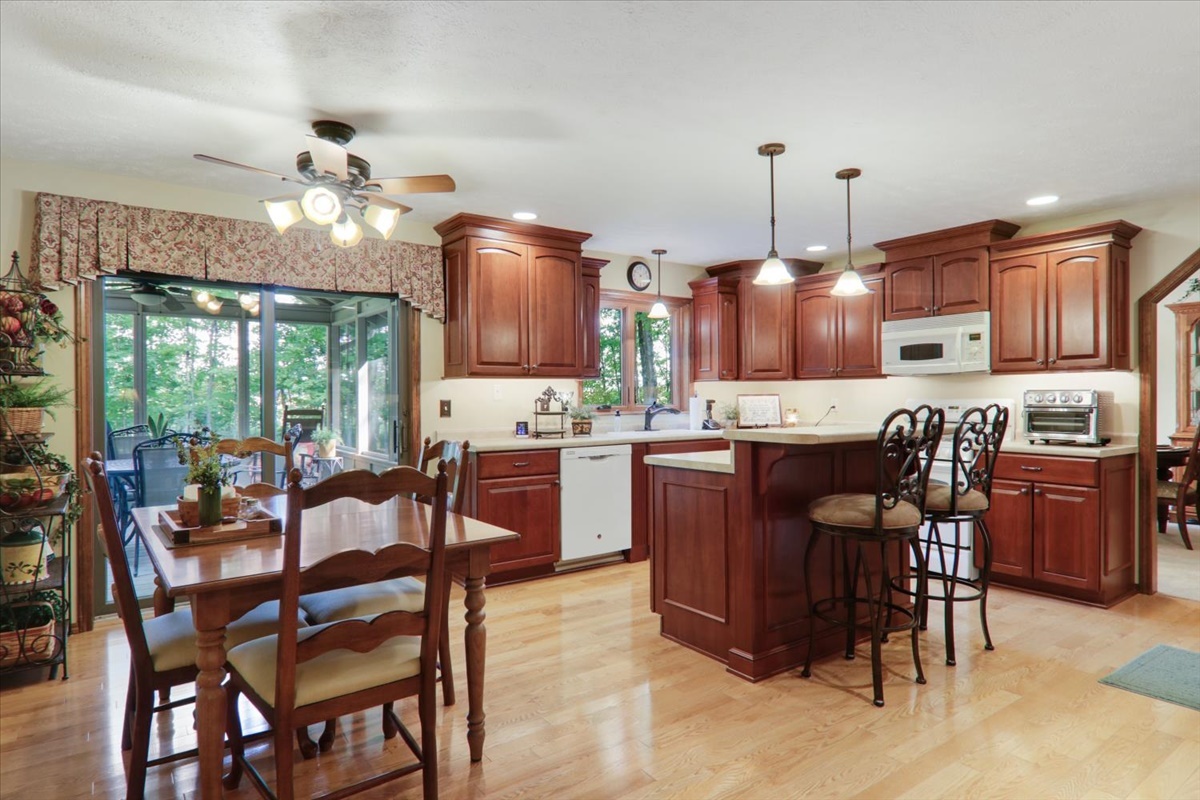 21 Bent Tree Lane Towanda, IL 61776 - Photo 12 of 49 a kitchen with a dining table chairs and stainless steel appliances