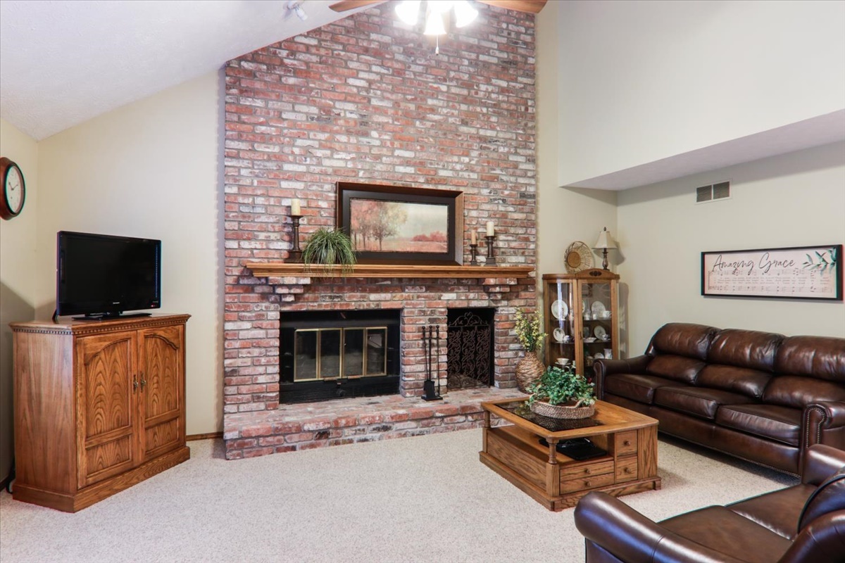 21 Bent Tree Lane Towanda, IL 61776 - Photo 6 of 49 a living room with furniture a flat screen tv and a fireplace