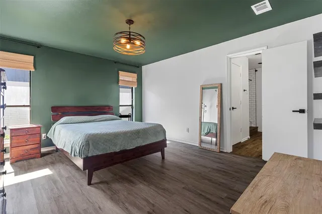 a bedroom with a bed and a chandelier