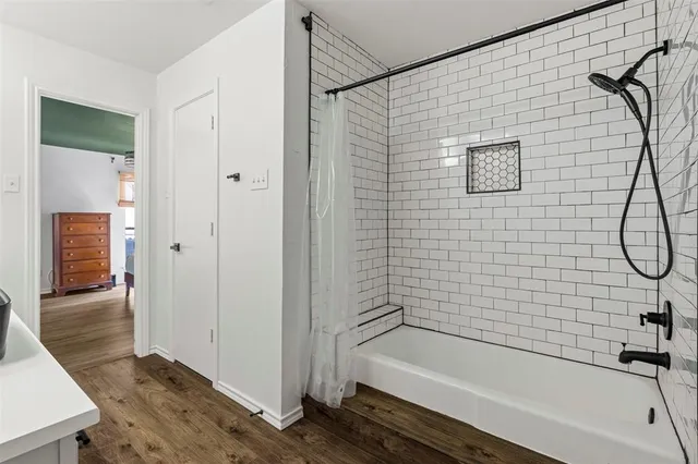 a bathroom with a shower and a bath tub