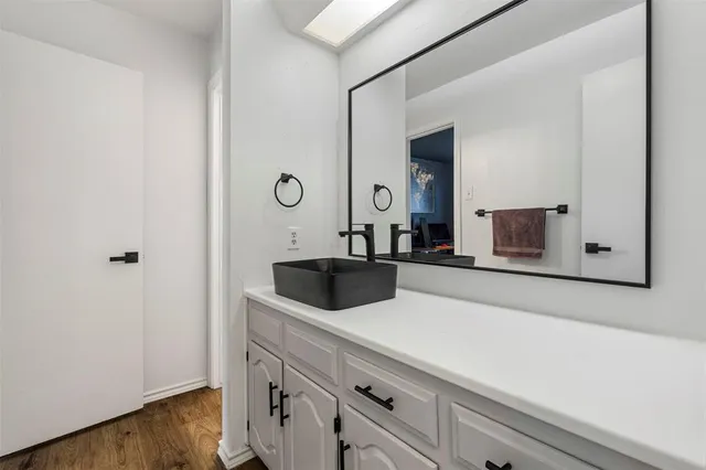 a bathroom with a sink and mirror
