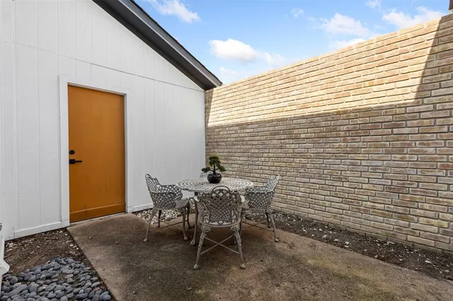 a view of a room with a table and chairs