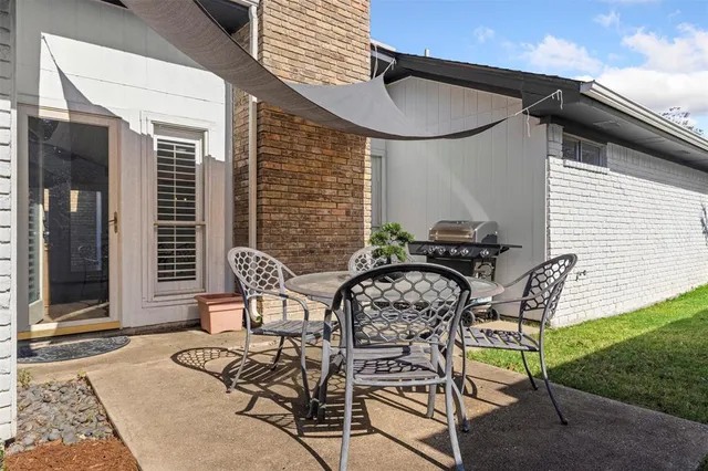 a view of a patio with table and chairs and potted plants
