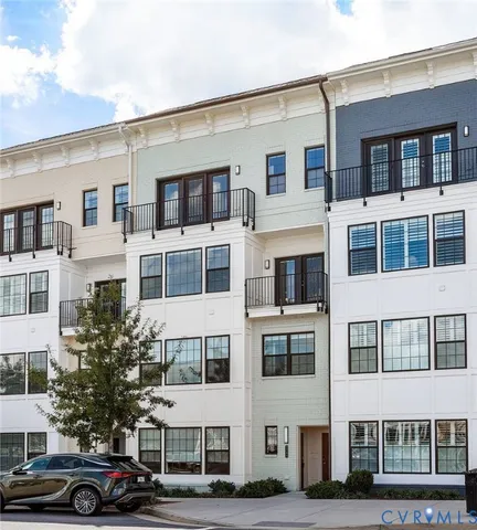 a front view of a residential apartment building with a yard