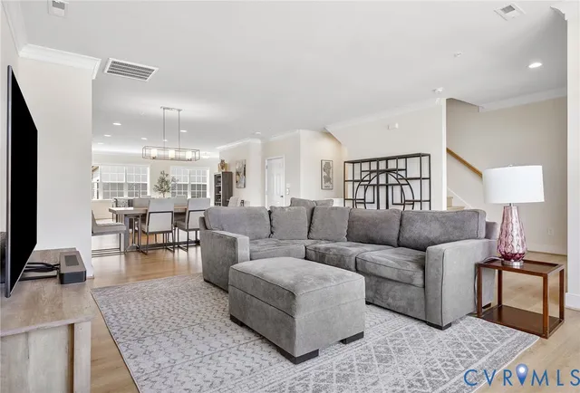 a living room with furniture and view of kitchen