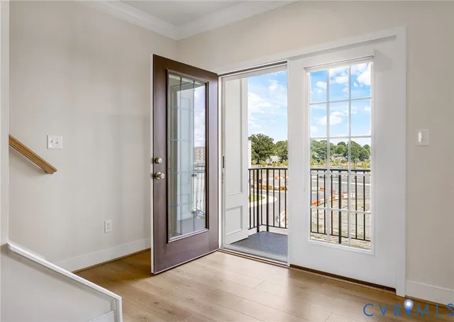 a view of a room with wooden floor and windows