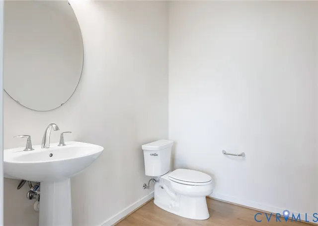 a bathroom with a sink a toilet and mirror