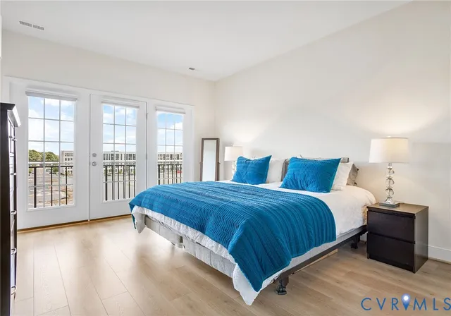 a bedroom with a large bed and a large window