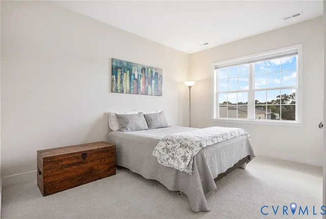 a spacious bedroom with a bed and a window