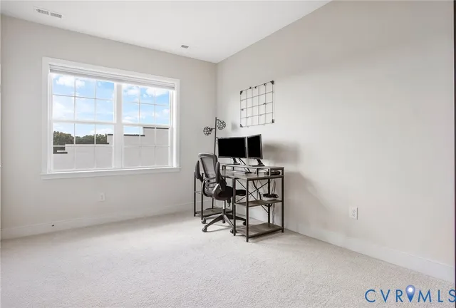 a view of workspace with furniture and window