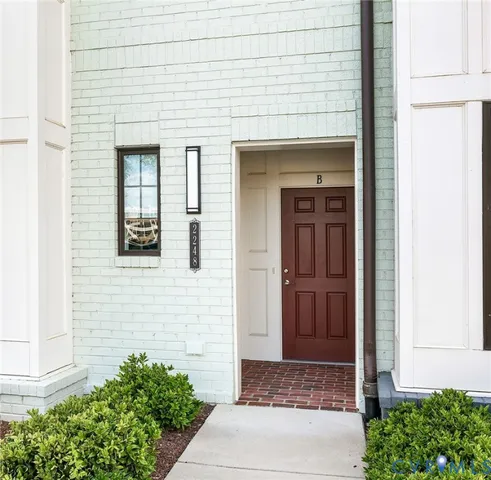 a front view of a house with white walls