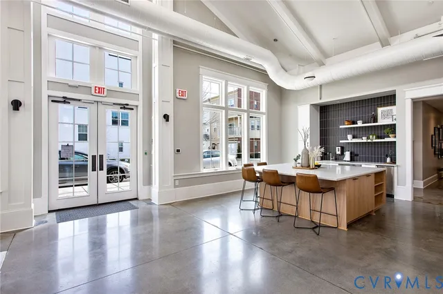 a living room with fireplace furniture and a large window