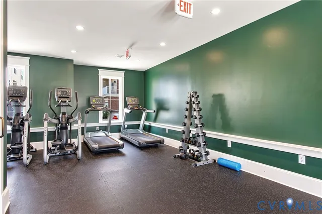 a room with gym equipment and large mirror