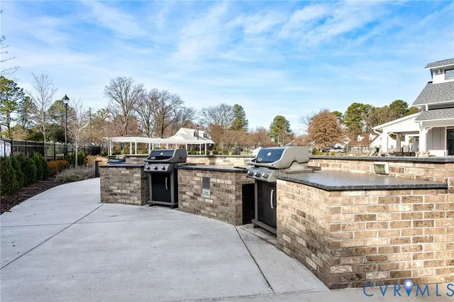 a view of a swimming pool with outdoor seating and a buildings