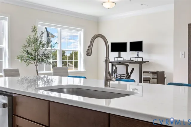 a kitchen with a sink and a large window