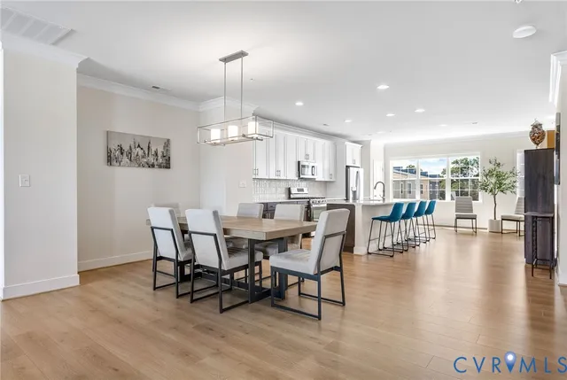 a view of a dining room with furniture wooden floor and chandelier