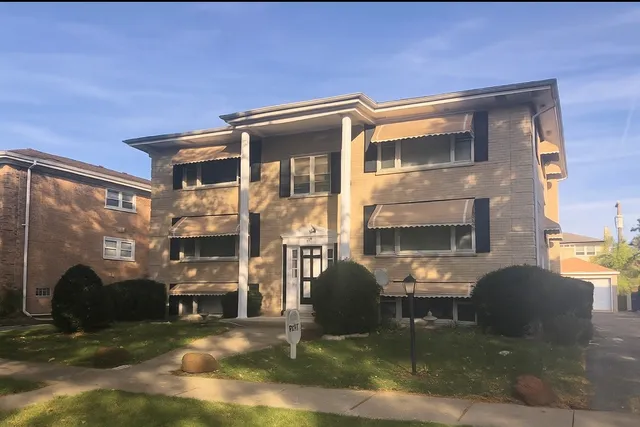 a building outdoor space with patio furniture and potted plants