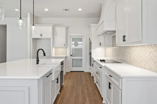 a view of kitchen with wooden floor and windows