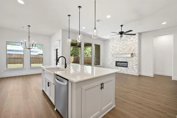 a kitchen with white cabinets appliances and a sink