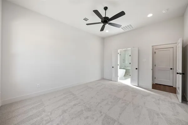 a large kitchen with a lot of counter space and wooden floor