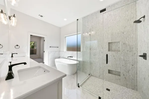 an empty room with a ceiling fan and a bathroom