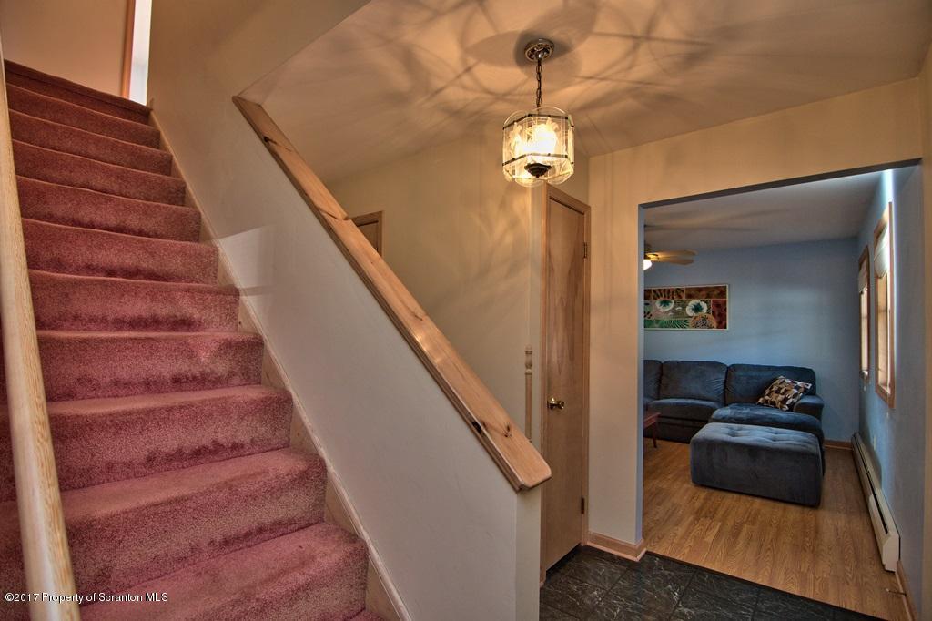 132 Thomas Road Moscow, PA 18444 - Photo 18 of 46 a view of a hallway with stairs and wooden floor