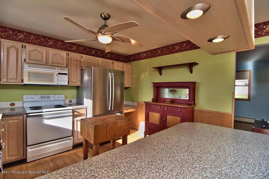132 Thomas Road Moscow, PA 18444 - Photo 2 of 46 a kitchen with stainless steel appliances granite countertop a sink refrigerator and cabinets