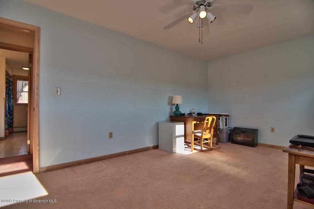 132 Thomas Road Moscow, PA 18444 - Photo 21 of 46 a room with gym equipment and a chandelier