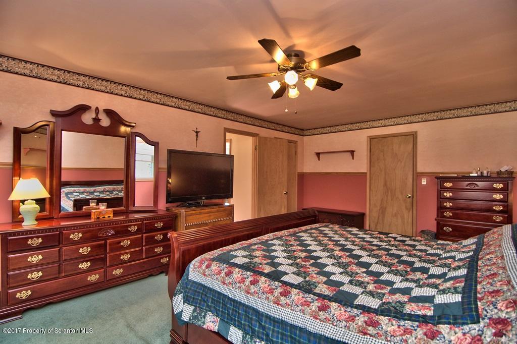 132 Thomas Road Moscow, PA 18444 - Photo 23 of 46 a bedroom with a bed and flat screen tv