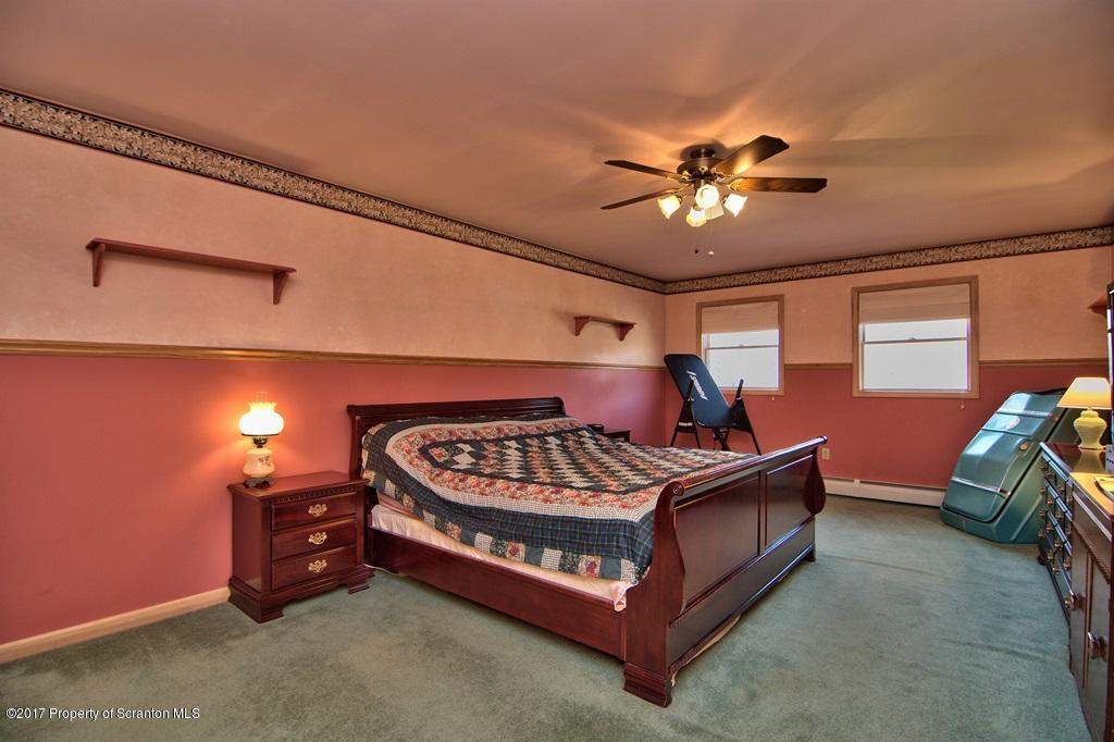 132 Thomas Road Moscow, PA 18444 - Photo 25 of 46 a bed sitting in a room next to a lamp