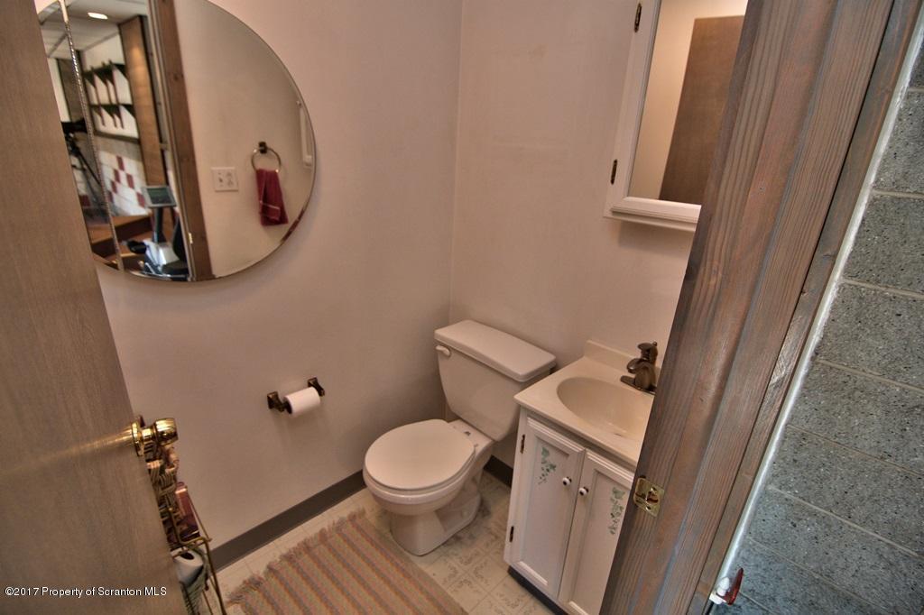 132 Thomas Road Moscow, PA 18444 - Photo 28 of 46 a white toilet sitting next to a small sink