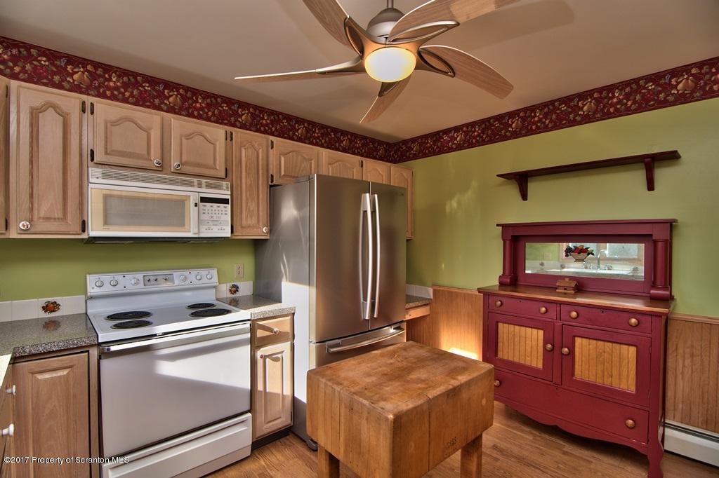 132 Thomas Road Moscow, PA 18444 - Photo 3 of 46 a kitchen with stainless steel appliances granite countertop a stove cabinets and microwave