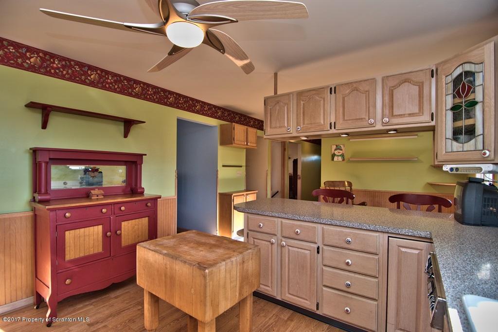132 Thomas Road Moscow, PA 18444 - Photo 4 of 46 a kitchen with cabinets and wooden floors