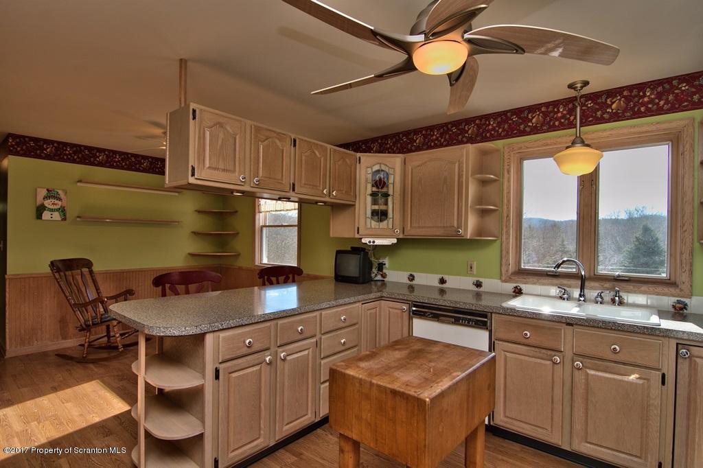 132 Thomas Road Moscow, PA 18444 - Photo 5 of 46 a kitchen with stainless steel appliances granite countertop a sink a stove cabinets counter space and a window