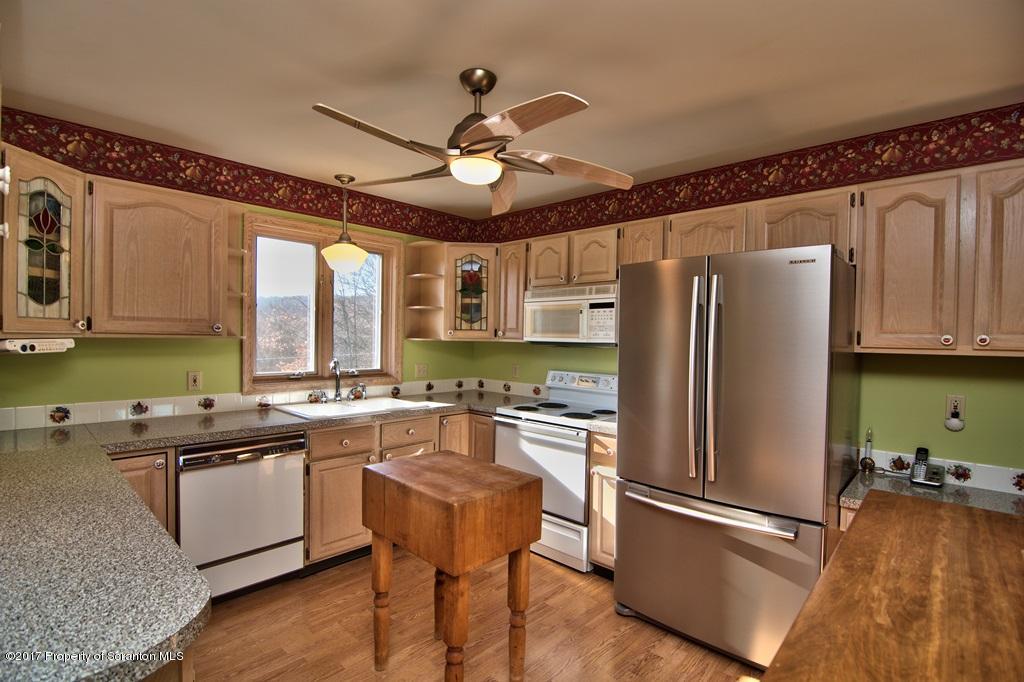 132 Thomas Road Moscow, PA 18444 - Photo 7 of 46 a kitchen with stainless steel appliances granite countertop a refrigerator a sink dishwasher a stove and white countertops with wooden floor