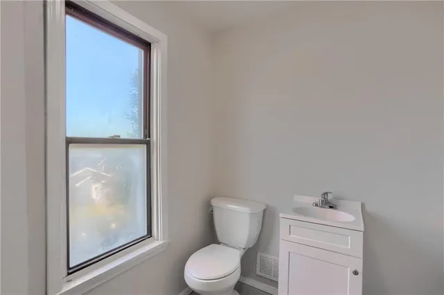 a white toilet sitting next to a bathroom sink