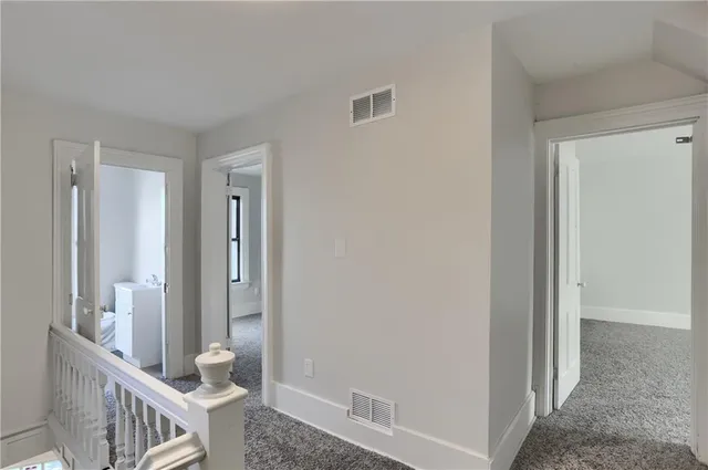 a view of a room with wooden floor and windows