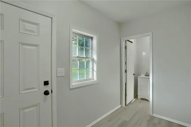 an empty room with windows and closet