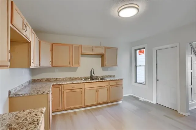 a kitchen with a sink and cabinets