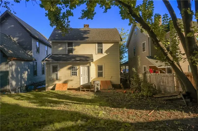 a front view of house with a garden