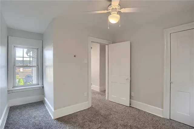 an empty room with windows and closet