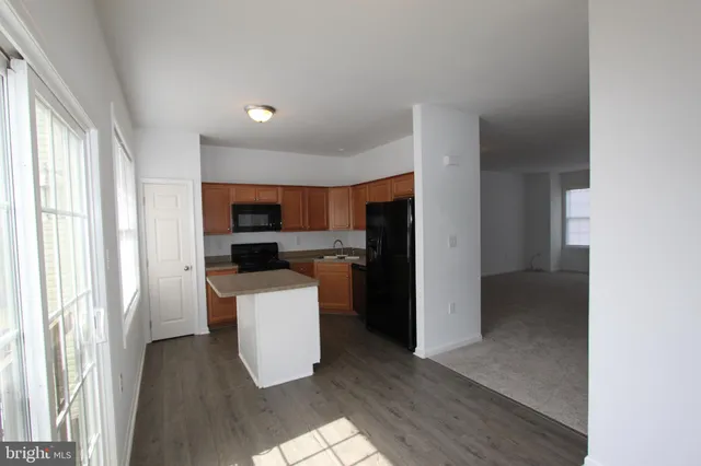 a kitchen with a refrigerator and a stove