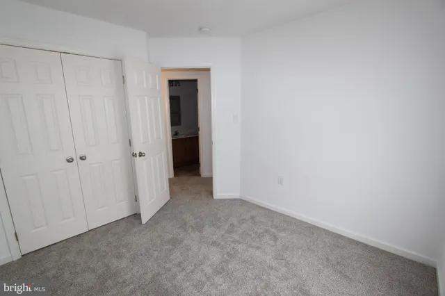 a view of an empty room with closet area